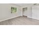 Simple bedroom with large window, closet, and new flooring at 124 Mercado Ave, Orlando, FL 32807