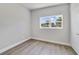 Well-lit bedroom featuring wood-look floors and a large window at 124 Mercado Ave, Orlando, FL 32807