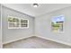 Simple bedroom with two large windows and gray flooring at 124 Mercado Ave, Orlando, FL 32807