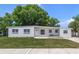 White single story house with green lawn and driveway at 124 Mercado Ave, Orlando, FL 32807