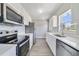 Modern kitchen with stainless steel appliances and white cabinets at 124 Mercado Ave, Orlando, FL 32807