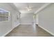 Bright living room with grey vinyl flooring and a view into the kitchen at 124 Mercado Ave, Orlando, FL 32807