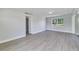 Living room with grey vinyl flooring and access to another room at 124 Mercado Ave, Orlando, FL 32807