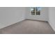 Spacious bedroom with neutral carpeting and large window at 1244 White Ash Loop, Deland, FL 32720