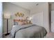 Bright bedroom with gray bedding, a floor lamp, and a large closet at 1244 White Ash Loop, Deland, FL 32720