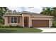 One-story home with brown garage door and red shutters at 1244 White Ash Loop, Deland, FL 32720