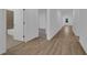 Bright hallway with light wood floors and access to bathroom and bedroom at 1244 White Ash Loop, Deland, FL 32720