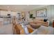 Open living room showcasing a neutral sectional sofa, a round wooden coffee table, and stylish armchairs at 1244 White Ash Loop, Deland, FL 32720