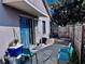 Small backyard patio with blue chairs and cooler at 1332 Azalea Way, Winter Garden, FL 34787