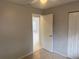 Neutral bedroom with tile flooring, a ceiling fan, an open closet, and a doorway to another room at 1332 Azalea Way, Winter Garden, FL 34787