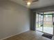 Bedroom with neutral walls, sliding door to back porch, with standard light fan and tile flooring at 1332 Azalea Way, Winter Garden, FL 34787