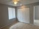 Neutral bedroom featuring tile flooring, a closet, and a window providing natural light at 1332 Azalea Way, Winter Garden, FL 34787