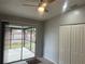 Bedroom with sliding door to back porch, neutral walls, and closet with standard ceiling fan at 1332 Azalea Way, Winter Garden, FL 34787