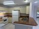 Kitchen area with white appliances, cabinets, and wooden countertops, with double stainless steel sink at 1332 Azalea Way, Winter Garden, FL 34787