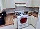 Efficient kitchen featuring gas range, ample counter space, and white cabinets at 1332 Azalea Way, Winter Garden, FL 34787