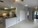 View of kitchen and dining area with tile floors, with white cabinets and appliances with a wooden counter at 1332 Azalea Way, Winter Garden, FL 34787