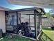 Cluttered screened porch with various items at 1332 Azalea Way, Winter Garden, FL 34787