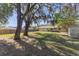 Fenced backyard with large oak trees and shed at 137 N Nowell St, Orlando, FL 32835