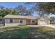 Ranch-style home with attached garage,mature landscaping, and a spacious yard at 137 N Nowell St, Orlando, FL 32835