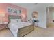 Bedroom with pink wall, full bed, and built-in desk at 1507 Aurora Ridge Dr, Zellwood, FL 32798