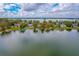 Aerial view of lakefront community showcasing multiple homes and lush landscaping at 1516 17Th Nw St, Winter Haven, FL 33881