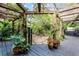 Lush back patio with pergola, stone path, & tropical plants at 1611 Walnut Ave, Winter Park, FL 32789