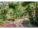 Serene courtyard oasis with stone path, pond, and tropical plants at 1611 Walnut Ave, Winter Park, FL 32789