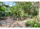 Relaxing courtyard with stone patio, lush landscaping, and seating area at 1611 Walnut Ave, Winter Park, FL 32789