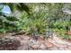 Tranquil courtyard with stone pathway, lush foliage & a small water feature at 1611 Walnut Ave, Winter Park, FL 32789