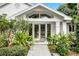 Inviting front entrance with lush landscaping and double doors at 1611 Walnut Ave, Winter Park, FL 32789