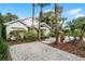 White house exterior with a driveway and tropical landscaping at 1611 Walnut Ave, Winter Park, FL 32789