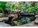 Serene pond nestled amongst lush tropical foliage at 1611 Walnut Ave, Winter Park, FL 32789