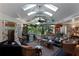 Sunroom with wicker furniture, a view of the garden, and skylights at 1611 Walnut Ave, Winter Park, FL 32789