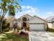 Brick house with two-car garage and landscaped yard at 1621 Riveredge Rd, Oviedo, FL 32766