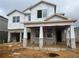 Two-story house under construction, featuring a covered porch and block exterior walls at 16881 Muskgrass Dr, Winter Garden, FL 34787