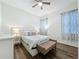 Bedroom features a ceiling fan and a cozy queen-sized bed at 190 Crepe Myrtle Dr, Groveland, FL 34736