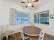 Bright dining area with hard floors, a ceiling fan, and natural light from two windows at 190 Crepe Myrtle Dr, Groveland, FL 34736