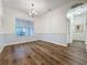 Well-lit dining room featuring hardwood floors, neutral paint, and a classic chandelier fixture at 190 Crepe Myrtle Dr, Groveland, FL 34736