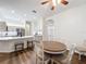 Bright kitchen featuring stainless steel appliances, white cabinets, breakfast bar, and a cozy dining area at 190 Crepe Myrtle Dr, Groveland, FL 34736