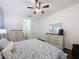 Comfortable main bedroom featuring hardwood floors, neutral paint, and an ensuite bathroom at 190 Crepe Myrtle Dr, Groveland, FL 34736