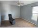 Bedroom with ceiling fan and comfortable armchair at 1901 Griff Wood Ct, Saint Cloud, FL 34772