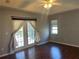 Spacious bedroom with dark wood floors and French doors leading outside at 1901 Griff Wood Ct, Saint Cloud, FL 34772