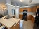 Kitchen with wood cabinets, black appliances, and ample counter space at 1901 Griff Wood Ct, Saint Cloud, FL 34772