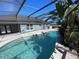 Relaxing pool area featuring a screened enclosure and lush landscaping at 1901 Griff Wood Ct, Saint Cloud, FL 34772