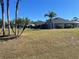 Large backyard with lush green grass and palm trees at 1901 Griff Wood Ct, Saint Cloud, FL 34772