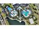 Aerial view of community pool, playground, and lake at 1919 Tropical Palms Cir, Kissimmee, FL 34747