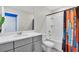 Bathroom with gray vanity, bathtub, and colorful shower curtain at 1919 Tropical Palms Cir, Kissimmee, FL 34747