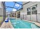 Resort-style pool with volleyball net and a screened enclosure at 1919 Tropical Palms Cir, Kissimmee, FL 34747