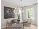 Bright dining room with modern light fixture and four chairs at 1997 Tohoqua Blvd, Kissimmee, FL 34744