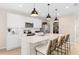 Modern kitchen with white cabinets, island, and stainless steel appliances at 1997 Tohoqua Blvd, Kissimmee, FL 34744